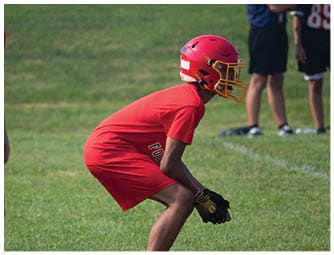 A group of football players on a field. Description generated by AI