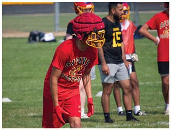 A group of football players on a field. Description generated by AI