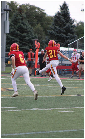A football player catching a ball. Description generated by AI