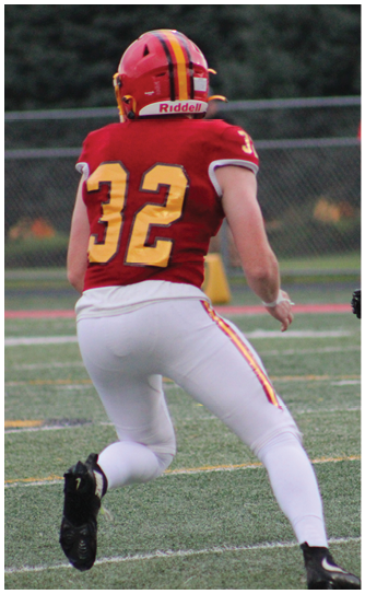 A football player catching a ball. Description generated by AI