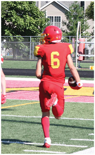 A football player catching a ball. Description generated by AI