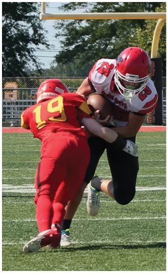 A football player catching a ball. Description generated by AI