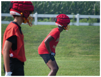 A group of football players on a field. Description generated by AI