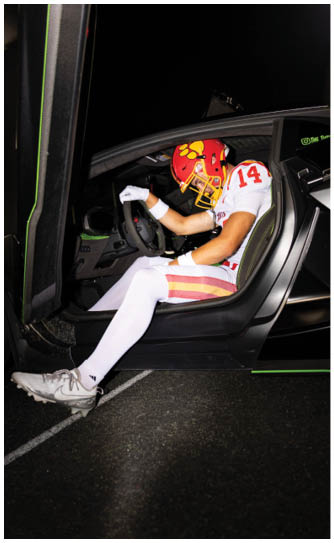 A football player catching a ball. Description generated by AI