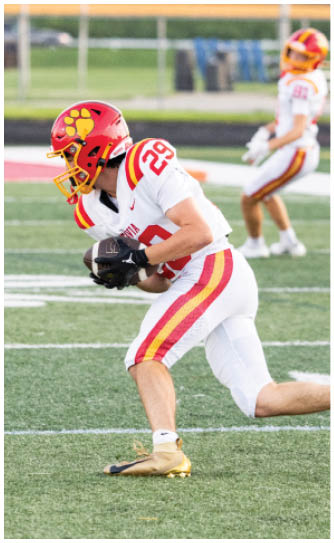 A football player catching a ball. Description generated by AI