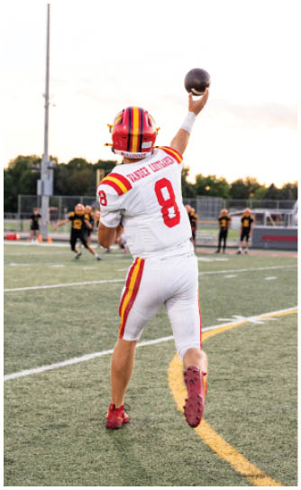 A football player catching a ball. Description generated by AI