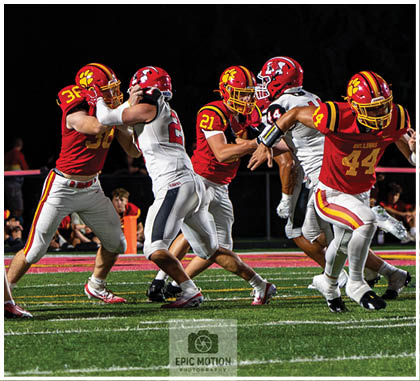A football player running on the field. Description generated by AI