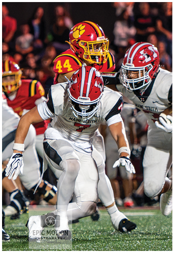 A group of football players celebrating a touchdown. Description generated by AI