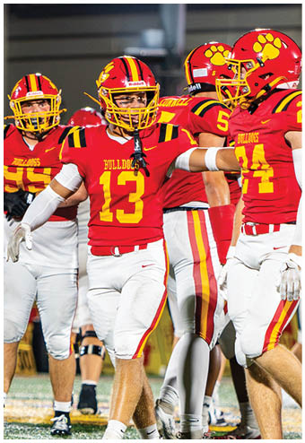 A group of football players celebrating a touchdown. Description generated by AI