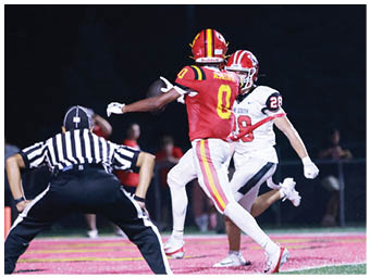 A football player running on the field. Description generated by AI