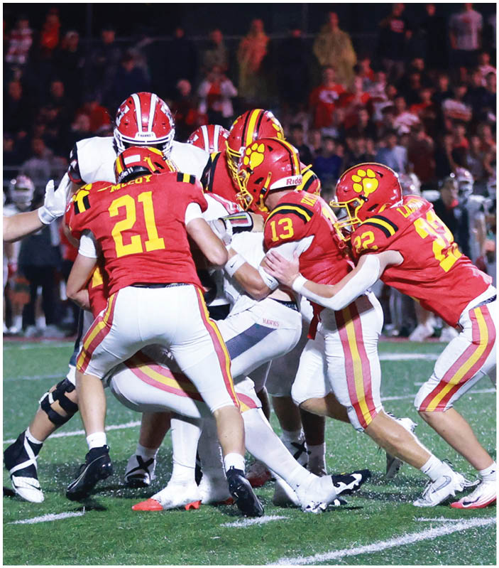 A group of football players on a field. Description generated by AI