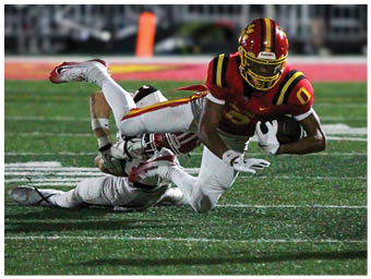 A football player running on the field. Description generated by AI