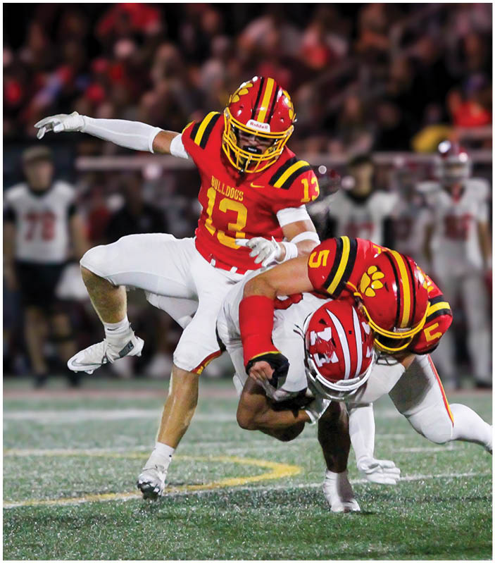 A group of football players on a field. Description generated by AI