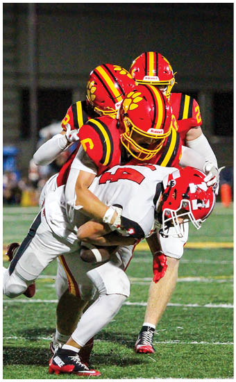 Two football players wearing blue and white uniforms. Description generated by AI