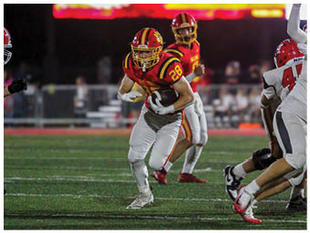 A football player running on the field. Description generated by AI