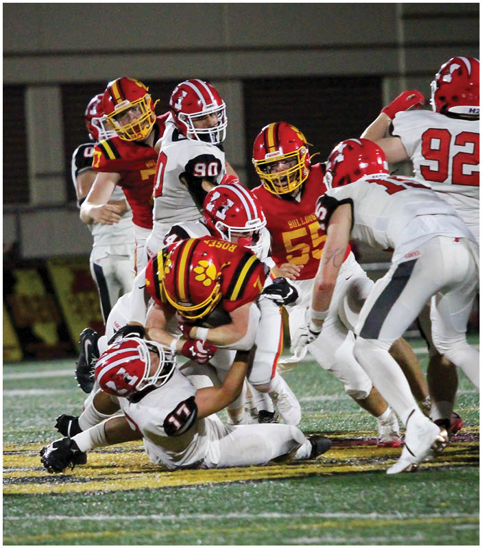 A group of football players on a field. Description generated by AI