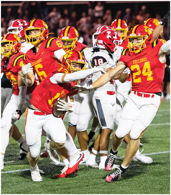 A group of football players on a field. Description generated by AI