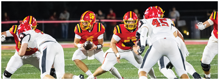 A group of football players on a field. Description generated by AI