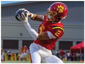 A football player running on the field. Description generated by AI