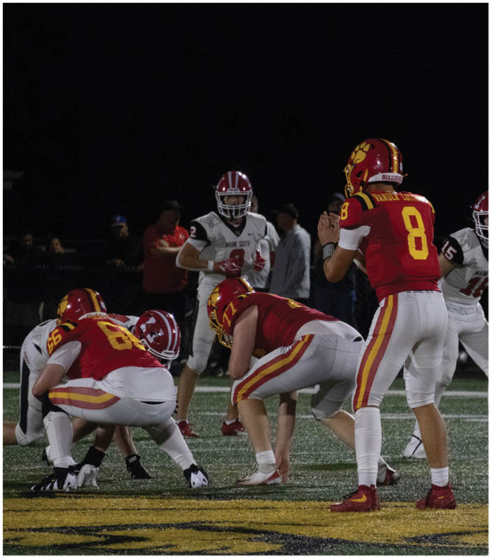 A group of football players on a field. Description generated by AI