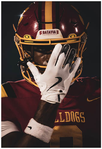 A group of football players celebrating a touchdown. Description generated by AI