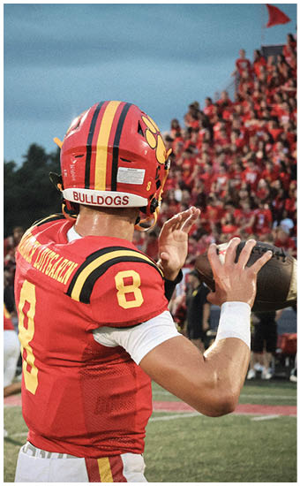 Two football players wearing blue and white uniforms. Description generated by AI