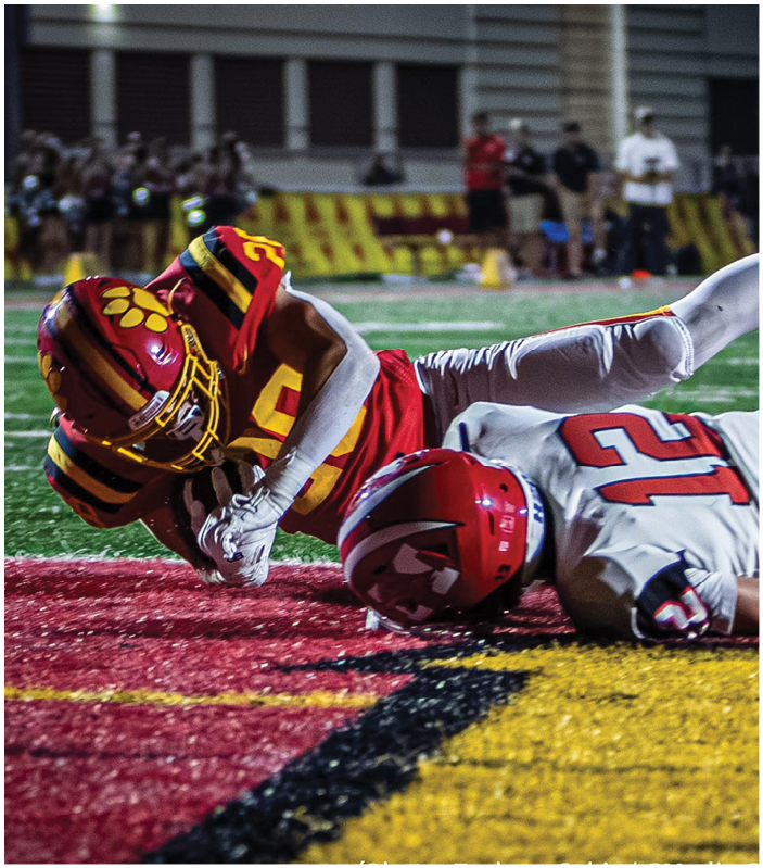 A group of football players on a field. Description generated by AI