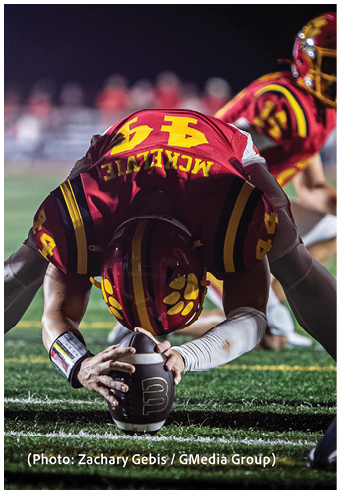 A group of football players celebrating a touchdown. Description generated by AI