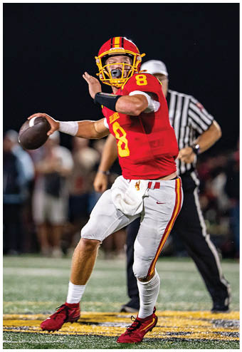 A group of football players celebrating a touchdown. Description generated by AI