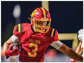 A football player running on the field. Description generated by AI