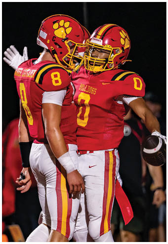 A group of football players celebrating a touchdown. Description generated by AI