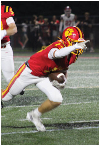 A group of football players celebrating a touchdown. Description generated by AI
