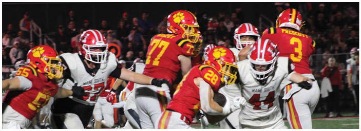 A group of football players on a field. Description generated by AI