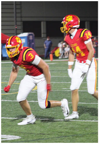 A group of football players celebrating a touchdown. Description generated by AI