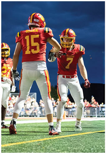 A group of football players celebrating a touchdown. Description generated by AI