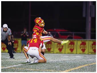 A football player running on the field. Description generated by AI