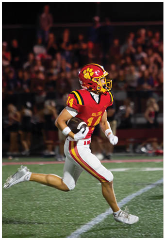 A group of football players celebrating a touchdown. Description generated by AI