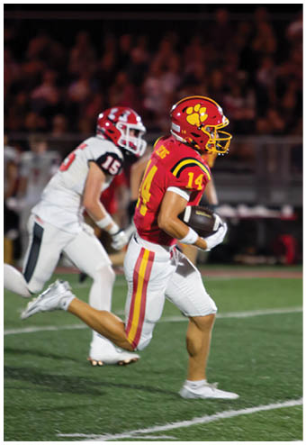A group of football players celebrating a touchdown. Description generated by AI