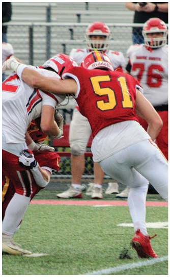 A football player catching a ball. Description generated by AI