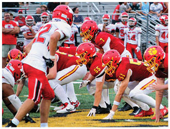 A group of football players on a field. Description generated by AI