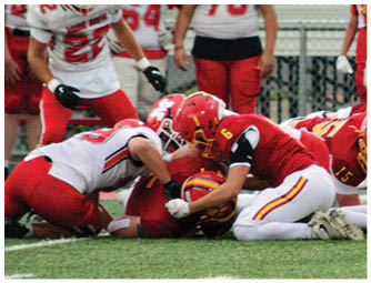 A group of football players on a field. Description generated by AI