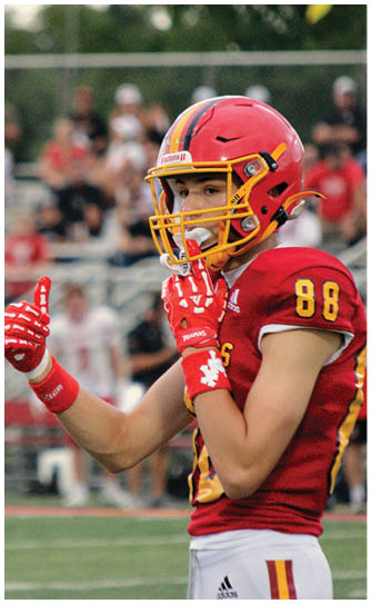A football player catching a ball. Description generated by AI