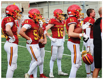 A group of football players on a field. Description generated by AI