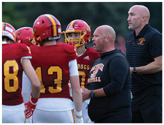 A group of football players on a field. Description generated by AI