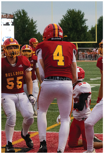 A football game is being played on a field. Description generated by AI