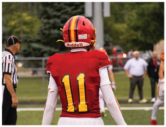 A group of football players on a field. Description generated by AI