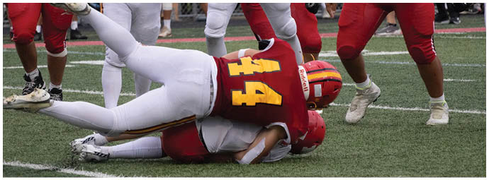 A football player wearing a blue and white uniform. Description generated by AI
