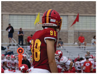A group of football players on a field. Description generated by AI