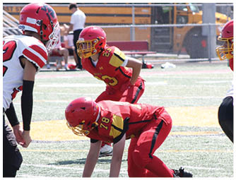 A group of football players on a field. Description generated by AI