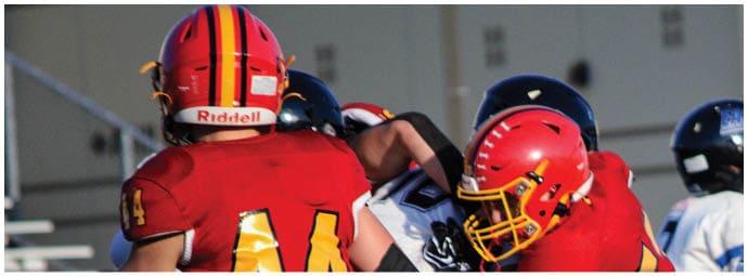 A football player wearing a blue and white uniform. Description generated by AI